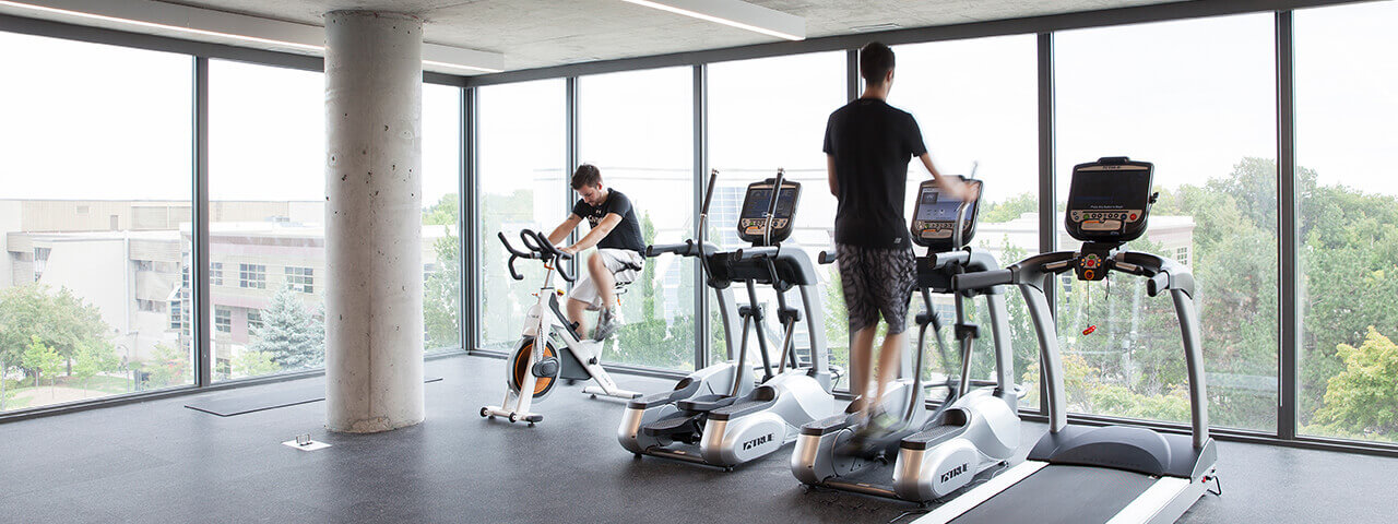 Residents exercising at Cetennial Place while overlooking Centennial College campus.