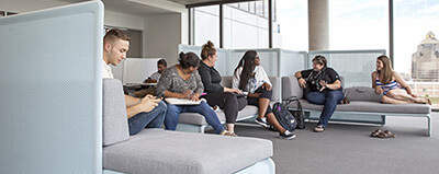 Student studying in fully furnished bedroom at Centennial Place.