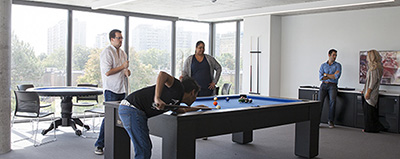 Group of residents playing billards at Centennial Place Studence Residence.